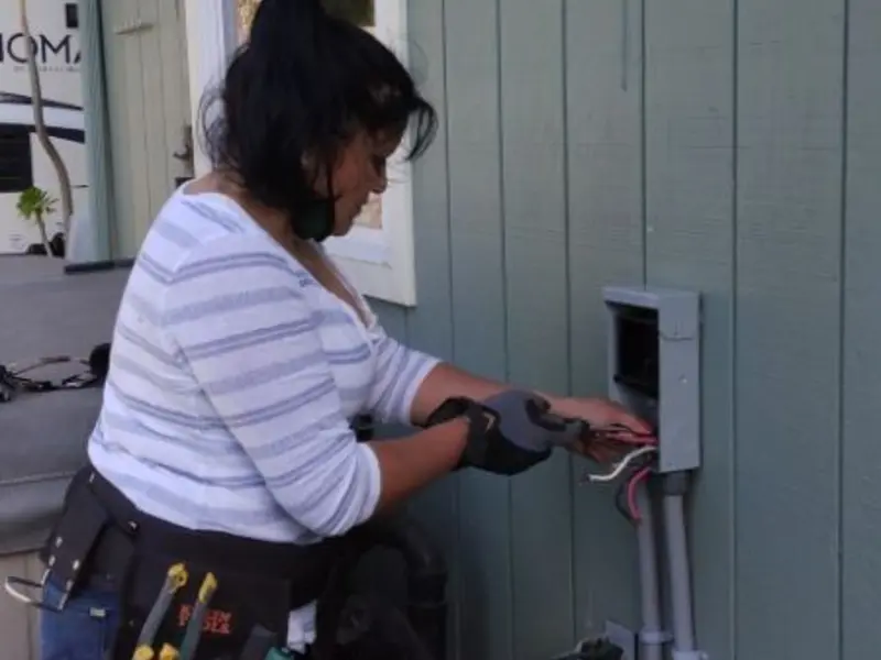 Licensed electrician wiring an exterior subpanel in Cumberland